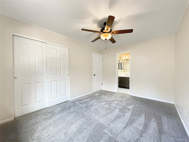 unfurnished bedroom with ensuite bathroom, a closet, ceiling fan, and carpet flooring