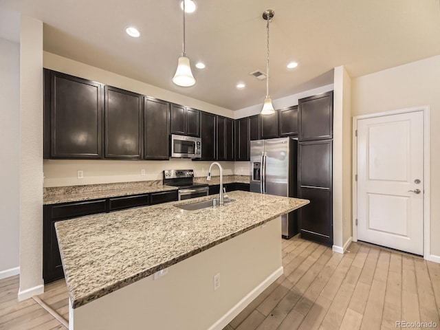 600 E Dry Creek Pl, Littleton, CO 80122 - kitchen featuring stainless steel appliances, light wood-style flooring, light stone countertops, pendant lighting, and recessed lighting
