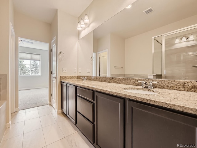 600 E Dry Creek Pl, Littleton, CO 80122 - bathroom with double vanity, tile patterned floors, and ceiling fan