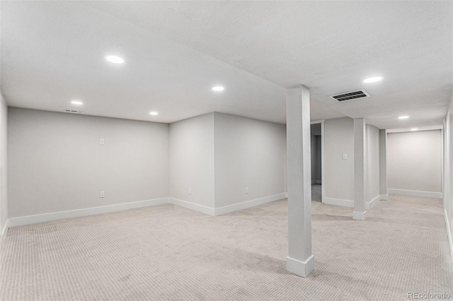 basement with light colored carpet and a textured ceiling