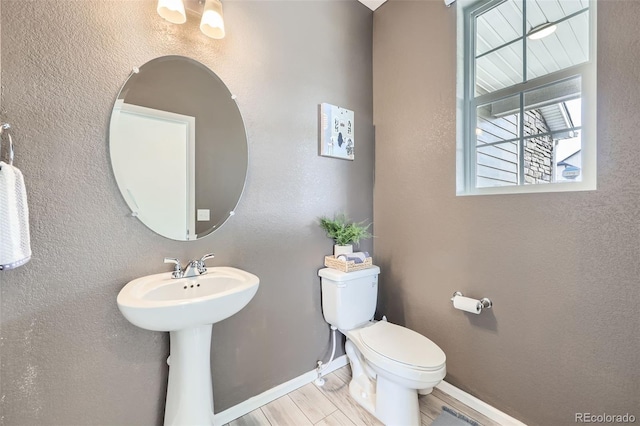 4433 N Picadilly Ct, Aurora, CO 80019 - bathroom with toilet, baseboards, and wood finished floors