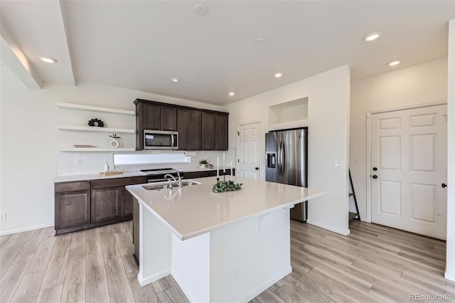 4433 N Picadilly Ct, Aurora, CO 80019 - kitchen featuring appliances with stainless steel finishes, a sink, light wood-type flooring, dark brown cabinetry, and light countertops