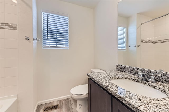 4433 N Picadilly Ct, Aurora, CO 80019 - full bathroom with vanity, toilet, wood finished floors, and baseboards