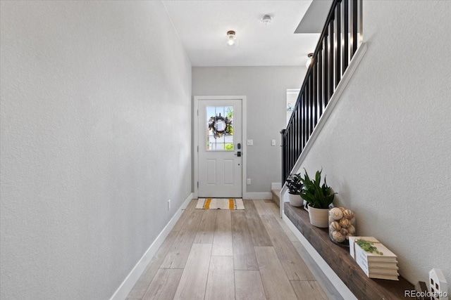 3344 Evening Pl, Castle Rock, CO 80109 - doorway with light wood-style flooring, stairs, and baseboards