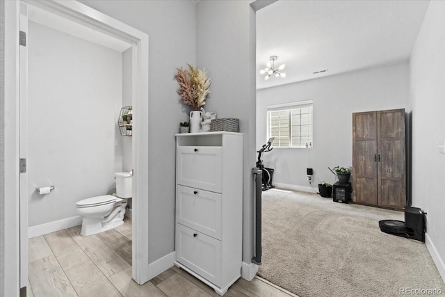 3344 Evening Pl, Castle Rock, CO 80109 - bathroom with toilet, baseboards, and a chandelier