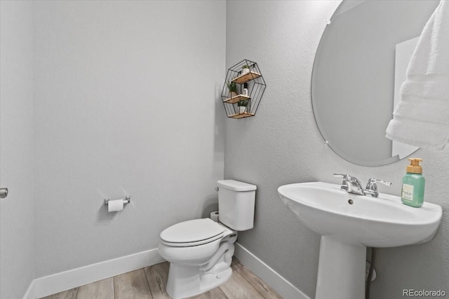 3344 Evening Pl, Castle Rock, CO 80109 - bathroom with wood finished floors, toilet, baseboards, and a sink