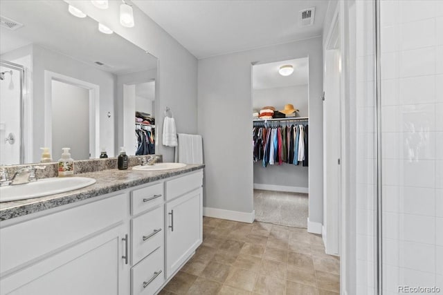 3344 Evening Pl, Castle Rock, CO 80109 - full bath with a walk in closet, double vanity, a stall shower, and baseboards
