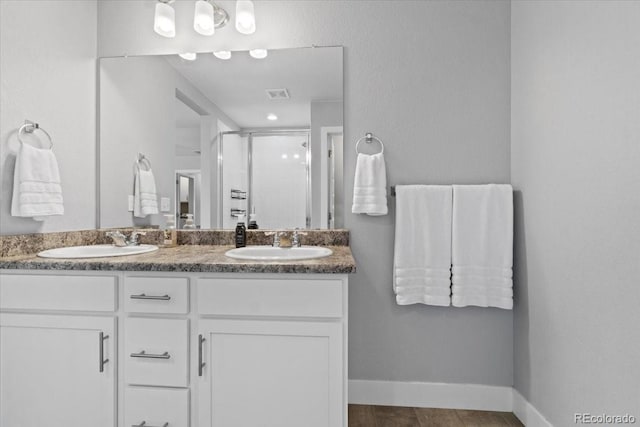 3344 Evening Pl, Castle Rock, CO 80109 - bathroom with a shower stall, double vanity, and baseboards