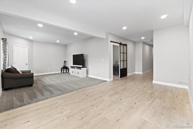 3344 Evening Pl, Castle Rock, CO 80109 - living room featuring a barn door, recessed lighting, wood finished floors, and baseboards