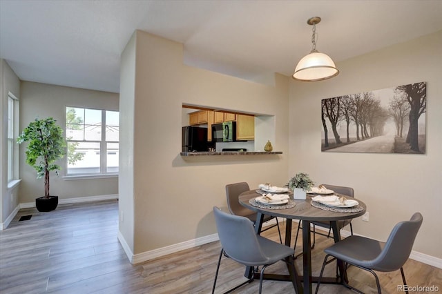 12812 Jasmine St Unit D, Thornton, CO 80602 - dining space featuring wood finished floors