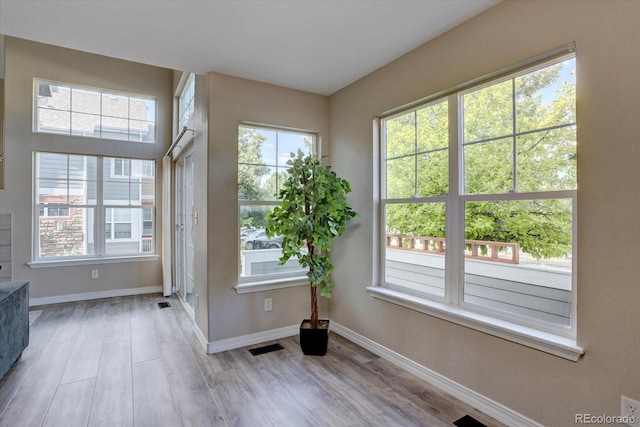 12812 Jasmine St Unit D, Thornton, CO 80602 - entryway featuring plenty of natural light and wood finished floors