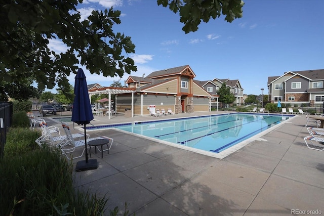 12812 Jasmine St Unit D, Thornton, CO 80602 - community pool featuring a patio and a residential view