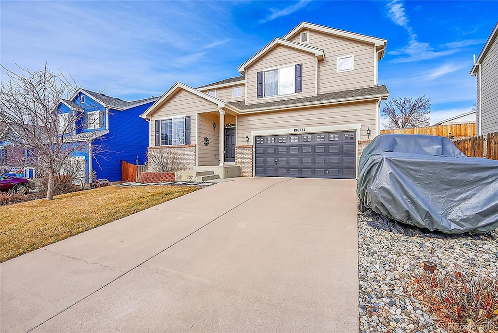 view of front facade featuring a front yard and a garage