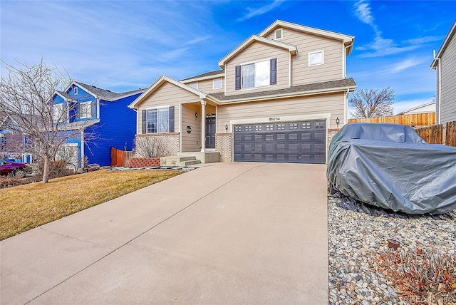 view of front facade featuring a front yard and a garage