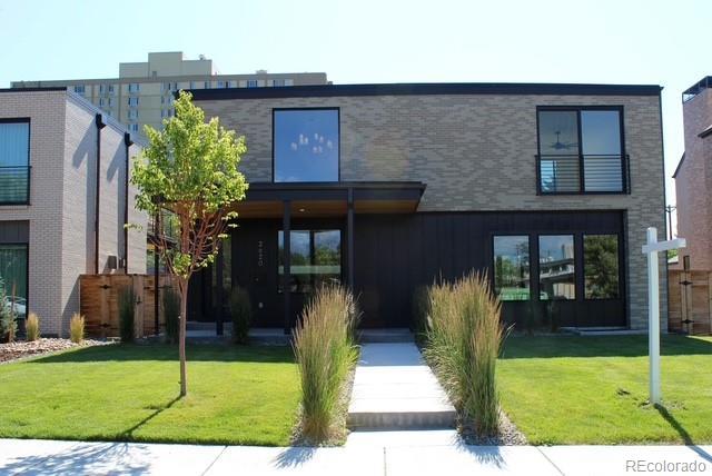2620 N Perry St, Denver, CO 80212 - view of front of house with a front yard and board and batten siding
