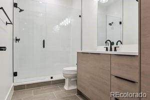 2620 N Perry St, Denver, CO 80212 - bathroom featuring vanity and a shower stall