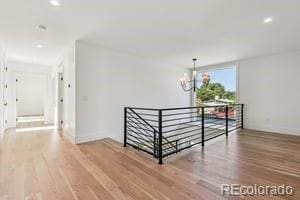 2620 N Perry St, Denver, CO 80212 - corridor featuring an upstairs landing, wood finished floors, a chandelier, and recessed lighting