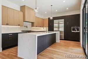 2620 N Perry St, Denver, CO 80212 - kitchen featuring light countertops, modern cabinets, hanging light fixtures, light wood finished floors, and recessed lighting