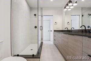 2620 N Perry St, Denver, CO 80212 - bathroom with a shower stall, double vanity, and recessed lighting