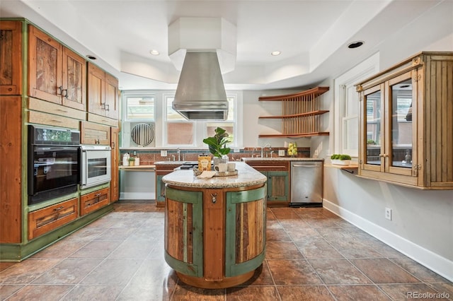 kitchen with wall oven, oven, tile patterned floors, a center island, and dishwasher