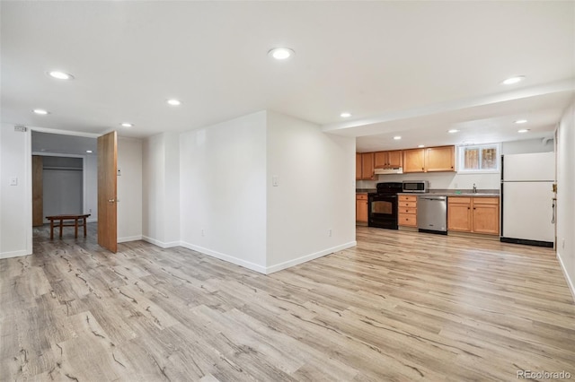 unfurnished living room featuring sink and light hardwood / wood-style floors