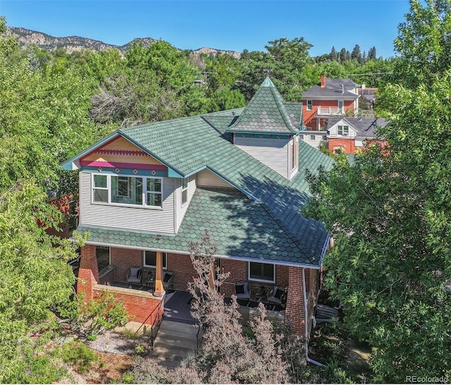 view of front of home featuring a mountain view and brick siding