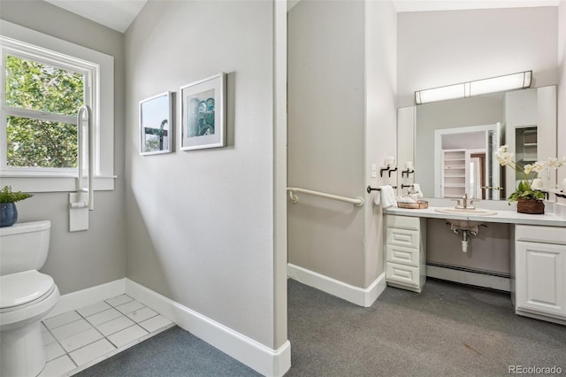 bathroom featuring vanity, tile patterned floors, baseboard heating, and toilet