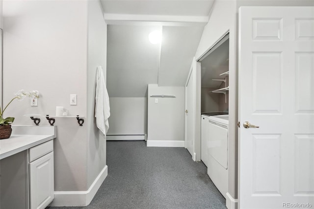 bathroom with vanity, washing machine and dryer, baseboard heating, and lofted ceiling