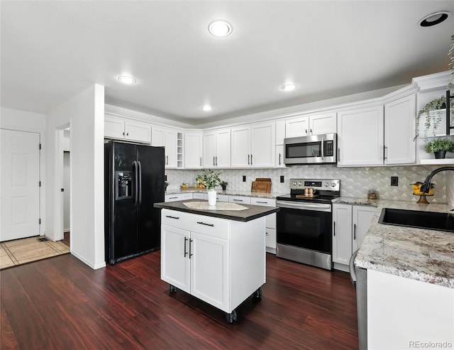 kitchen with stainless steel appliances, backsplash, dark wood-type flooring, white cabinets, and recessed lighting