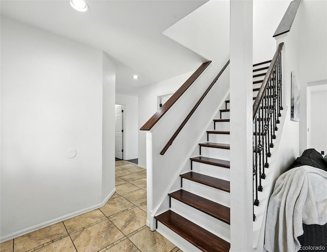 stairway featuring recessed lighting and tile patterned floors