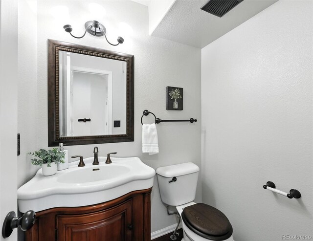 bathroom with toilet and vanity