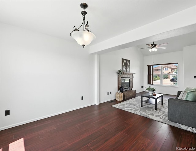 living room featuring a brick fireplace, wood finished floors, a ceiling fan, and lofted ceiling