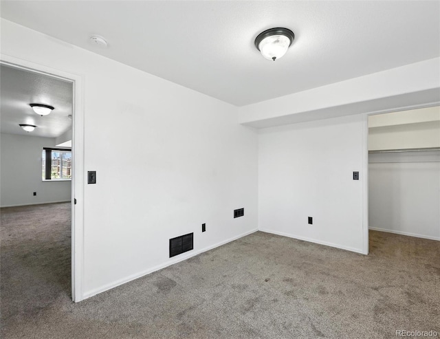 unfurnished bedroom featuring carpet and a spacious closet