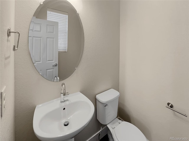 bathroom with toilet and sink