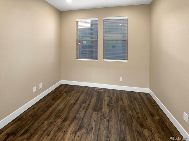 unfurnished room featuring dark hardwood / wood-style flooring