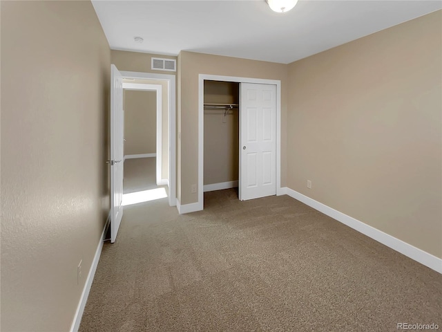 unfurnished bedroom with a closet and carpet floors