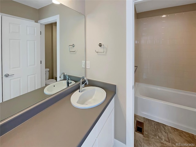 full bathroom with vanity, toilet, and tiled shower / bath