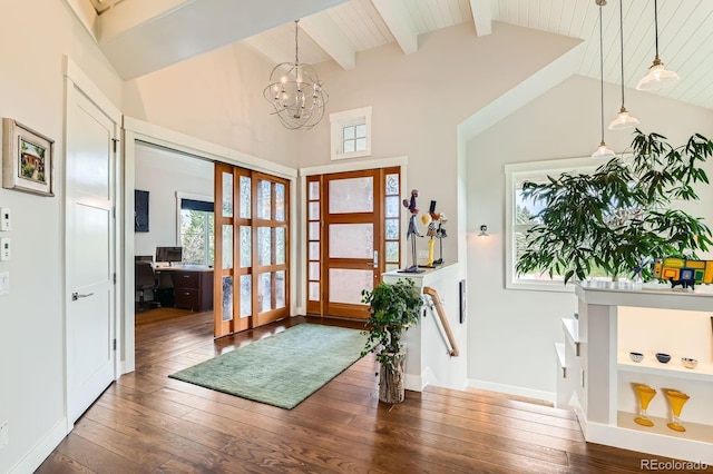 entrance foyer featuring baseboards, lofted ceiling with beams, an inviting chandelier, and dark wood-type flooring
