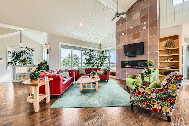 living room with wood-type flooring, a fireplace, high vaulted ceiling, and ceiling fan