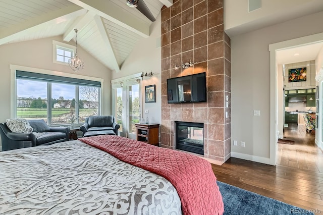 bedroom featuring beam ceiling, hardwood / wood-style floors, baseboards, high vaulted ceiling, and a tiled fireplace
