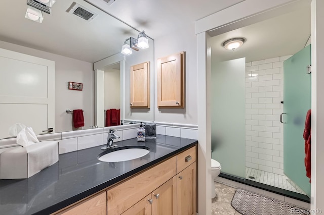 bathroom with visible vents, vanity, toilet, tile patterned floors, and a shower stall