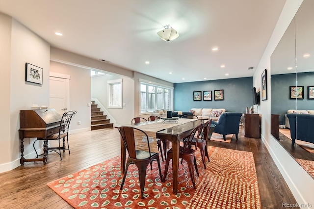 dining room featuring recessed lighting, baseboards, stairs, and hardwood / wood-style floors