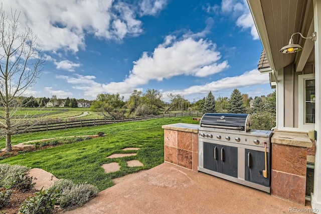 view of patio featuring exterior kitchen and fence