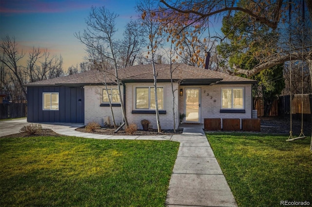 7320 W 21st Ave, Lakewood, CO 80214 - ranch-style home with board and batten siding, roof with shingles, and brick siding