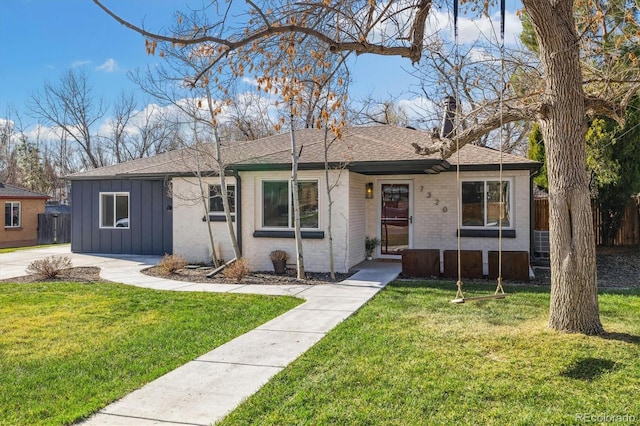 7320 W 21st Ave, Lakewood, CO 80214 - single story home with board and batten siding, roof with shingles, and brick siding