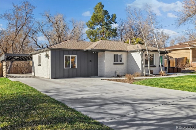 7320 W 21st Ave, Lakewood, CO 80214 - single story home with driveway, board and batten siding, fence, brick siding, and roof with shingles