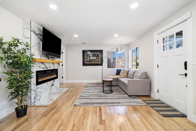 7320 W 21st Ave, Lakewood, CO 80214 - living area with wood finished floors, a fireplace, recessed lighting, and baseboards