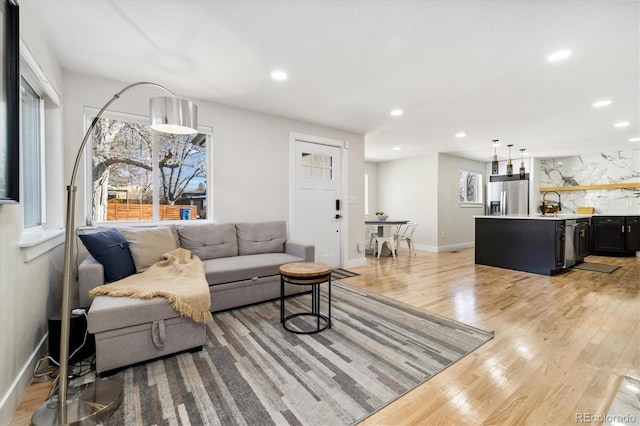 7320 W 21st Ave, Lakewood, CO 80214 - living room with light wood-style floors, healthy amount of natural light, recessed lighting, and baseboards