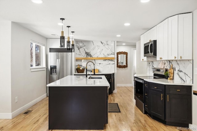 7320 W 21st Ave, Lakewood, CO 80214 - kitchen with stainless steel appliances, open shelves, decorative backsplash, a sink, and white cabinetry