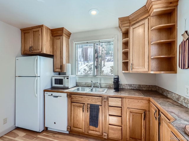 kitchen with white appliances, light wood-type flooring, open shelves, and a sink